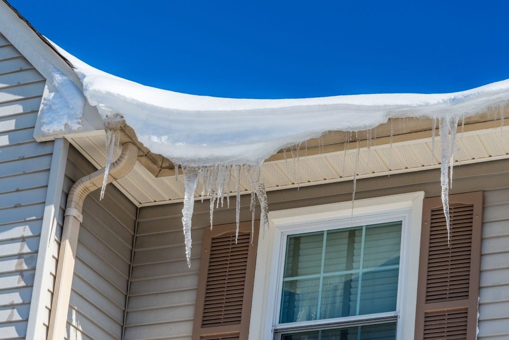 Gutter cleaning preventing ice dams and water damage