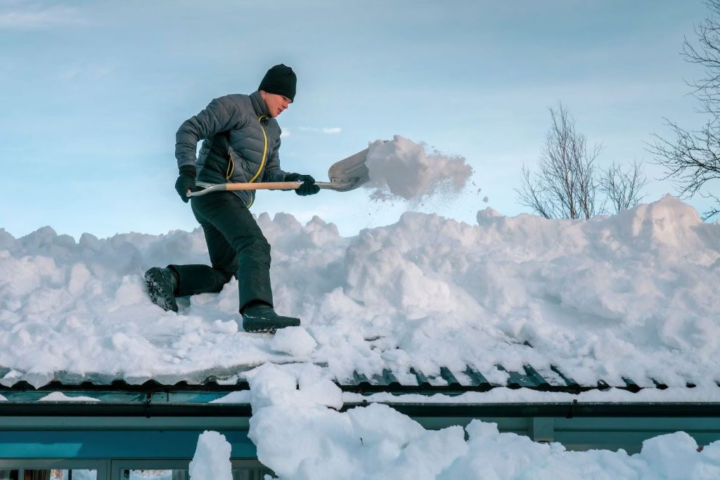 Utilizing a roof rake safe snow removal